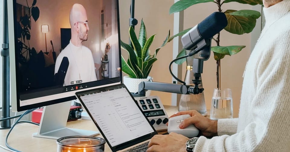 Christos Stavrou im Studio am Arbeiten mit KI-Chatbot über Community-Feedback und datenbasiertes Content-System.